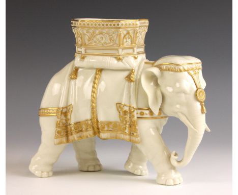 A Royal Worcester porcelain model of a capronised elephant bearing a howdah by James Hadley, 19th century, the white glazed b
