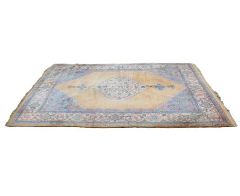A thick pile Turkish Oushak wool carpet, in yellow, blue and pink colourways, the central serrated lozenge on a yellow ground
