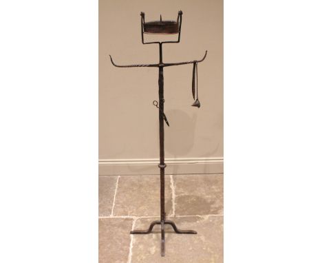 A 19th century freestanding iron pricket candle stand, possibly continental, with a swing candle well over a pair of rope twi