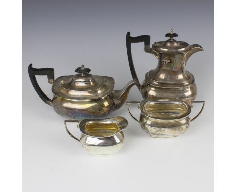 A George V silver tea service, Walker and Hall, Sheffield 1934, comprising a hot water jug, teapot, sugar bowl and milk jug, 