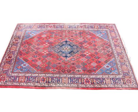 A fine hand woven washed red ground Persian Joshagan carpet, in red, blue and ivory colourways, the central graduated lozenge