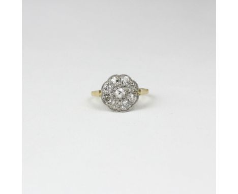 An early 20th century diamond cluster ring, the central old cut diamond within surround of eight old cut diamonds, within whi