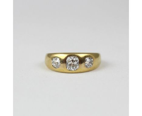 A 19th century three stone diamond ring, the central old cut diamond with smaller old cut diamond to each side, set in a yell