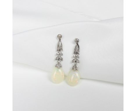 A pair of early 20th century opal and diamond earrings, the round cut diamond suspending stylised round cut diamond set leave