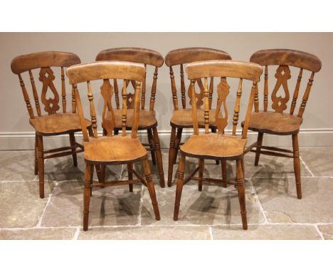 A matched set of six Victorian elm and beech kitchen chairs, later stripped, each with a pierced splat and lath back over a f