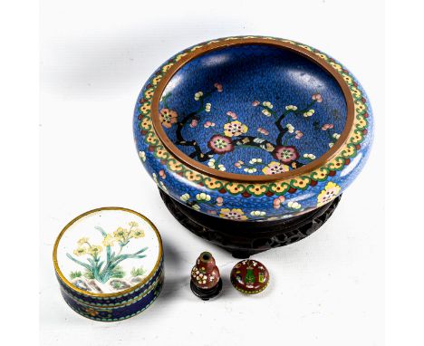 A Japanese blue ground cloisonne enamel bowl, with prunus tree decoration, diameter 20cm, on wood stand, a circular cloisonne