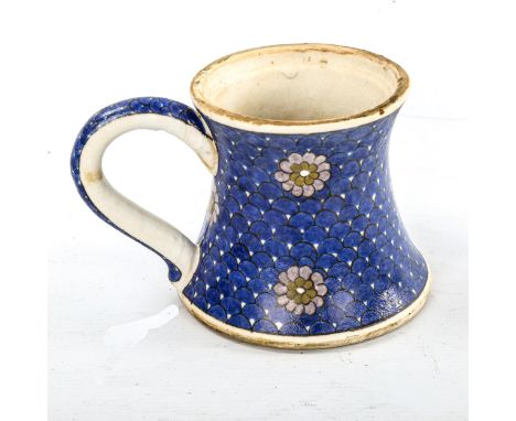 A Turkish pottery mug, with painted flowers on blue scale ground, height 11cmVery good condition 