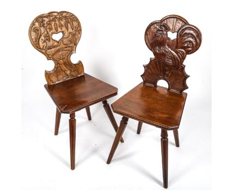 A pair of German Brettstuhl / Tyrolean chairs by Hans Thoma of Bernau, with relief carved backs depicting cockerel and squirr