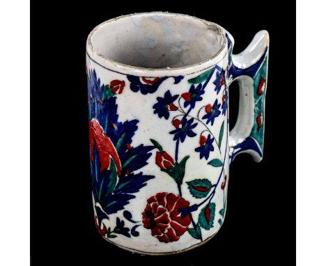 A Turkish pottery pint mug, with painted enamel decoration, height 13cmTop rim is unglazed, no sign of chips or cracks 
