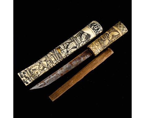 A Japanese relief carved bone dagger, Meiji Period circa 1900, decorated with Samurai Warriors, length 33cmBlade is rusted an