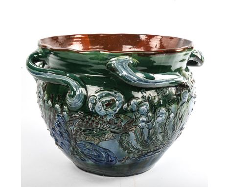 C H BRANNAM for BARNSTAPLE POTTERY - a large scale handmade pottery jardiniere, incised and raised stylised fish designs with