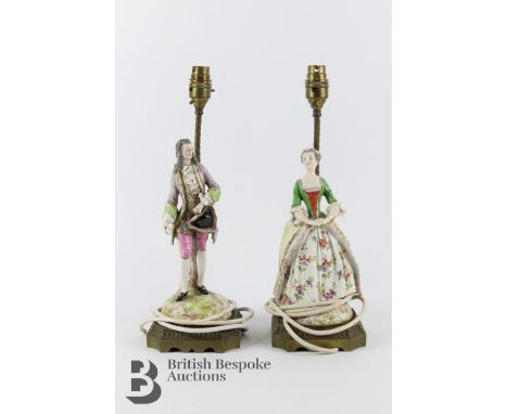Pair of porcelain figures, in the form of a gentleman and lady, surmounted to a brass lamp base, crossed arrow blue under-gla