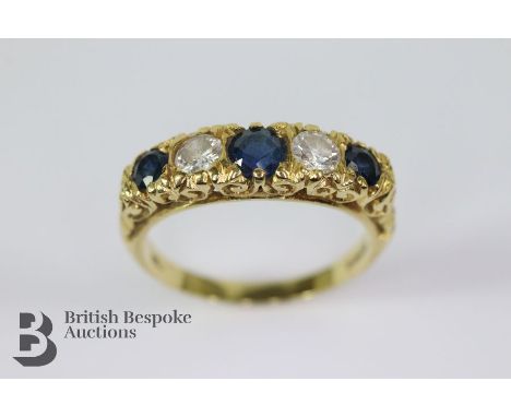 Early 20th century 18ct yellow gold sapphire and diamond ring. The ring set with three midnight-blue sapphires, centre stone 