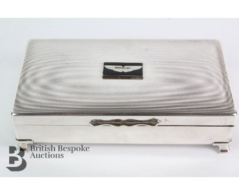 A 1970s desk top silver plated cigarette and cigar box to promote Aston Martin cars, approx 17 x 9 x 4 cms.&nbsp;