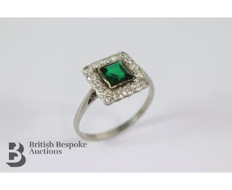 Antique platinum square-cut emerald and diamond ring. The emerald measures 5 x 5mm, surrounded by approx 70 pts of dias, size