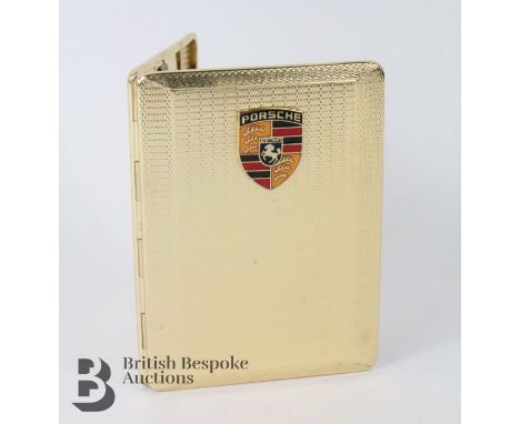 Har Bros pocket cigarette case, with gold-plated finish with an enamelled Porsche logo to the front, appears unused.&nbsp;