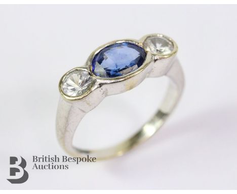 Bespoke 14/15ct white gold Ceylonese sapphire ring. The sapphire measures 7 x 5.5 mm, surrounded by white spinel/zircon, size