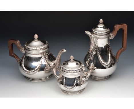 French silver tea pot, coffee pot and sugar basin of baluster form with embossed swag decoration, shaped handles and stylised