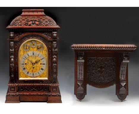 A late Victorian oak bracket clock the acanthus scroll gilt arch dial with silvered Roman chapter ring, Arabic five minutes a
