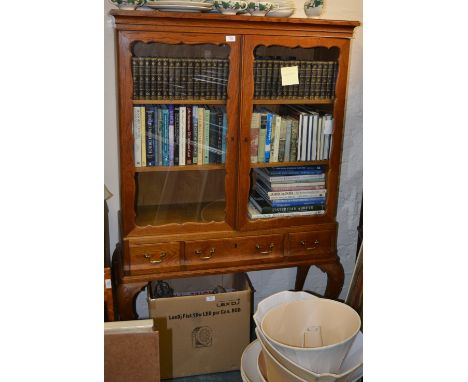 Georgian style display cabinet with glazed doors containing three shelves over three short drawers, raised on carved cabriole