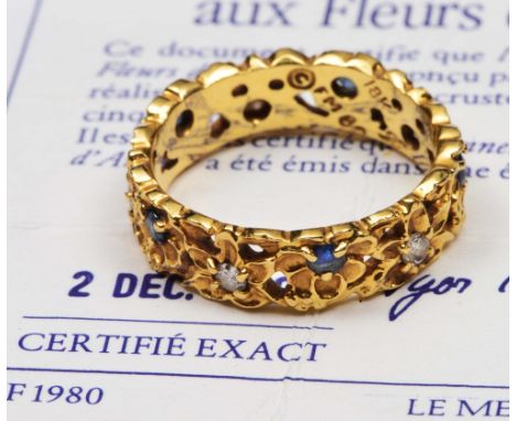 Faberge 18ct gold eternity ring with stylised floral setting of five diamonds and five sapphires in original box and with cer