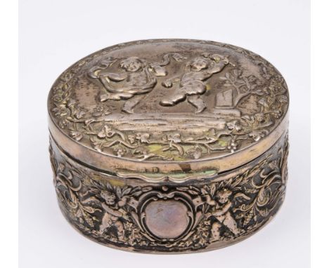 Silver trinket box  of oval form with rising lid and embossed cherub and acanthus decoration