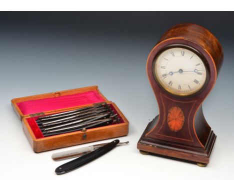 An Edwardian mahogany mantel clock with waisted case with inlaid string decoration and inlaid shell finish, together with a s