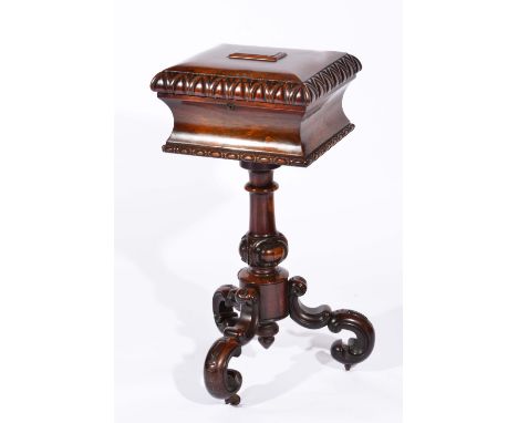 Victorian rosewood teapoy the interior fitted with two compartments, having a carved dome cover on scroll tripod supports, 38