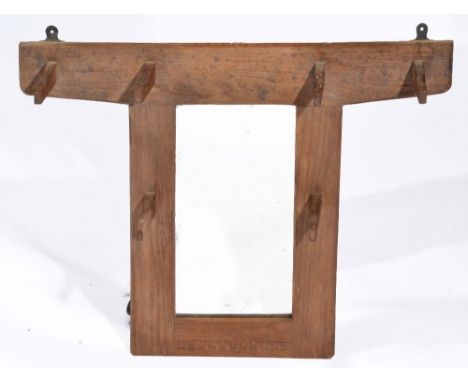 Arts & Crafts oak wall mirror/coat rack in the manner of Stanley Webb Davies with six stylised pegs and simple carved decorat