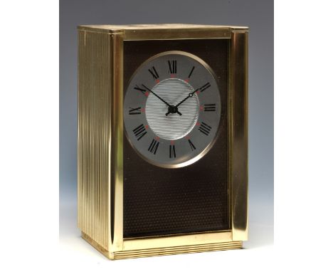 An Alcan mid century mantel timepiece with silvered Roman chapter ring, textured dial mask and reeded and angled brass case, 