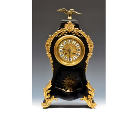 A late 19th Century French mantel clock the gilt brass dial with black and white enamelled Roman chapters, twin train movemen