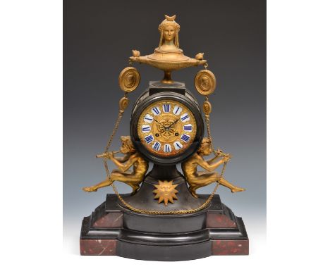 A 19th Century French mantel clock, the cast gilt dial with blue and white enamelled Roman chapters, the drum movement with o