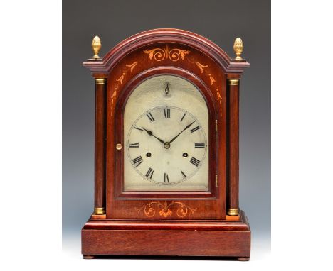 A Hamburg American Clock Company mahogany mantel clock the arched silvered Roman dial with silent/chime dial, twin train move