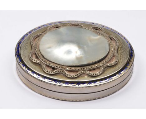 French silver pill box of oval form with beaded decoration, mother of pearl inlaid lid and blue enamel borders