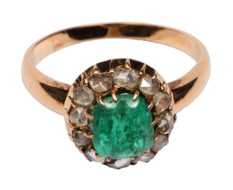 Unmarked ring set with central cabochon emerald surrounded by diamonds