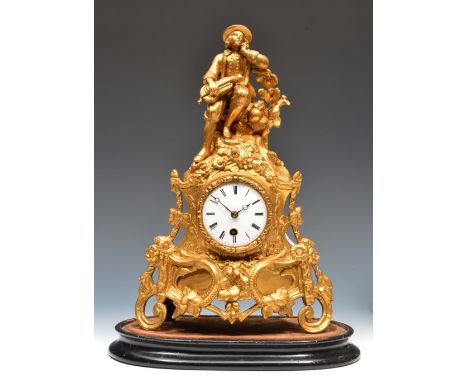 A 19th Century French gilt metal mantel timepiece with white enamel Roman dial, the figural case decorated with a seated gent