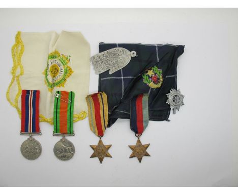 WWII Group of Four Medals, consisting of 39/45 Star, Africa Star, Defence and War Medal. A white metal Royal Army Service Cor