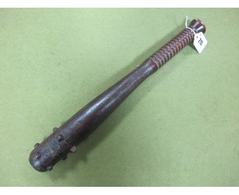 A WWI Trench Club, wood with lead insert, army boot studs at head.