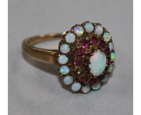 A 9ct gold, ruby and white opal cluster dress ring, one ruby missing, size P.