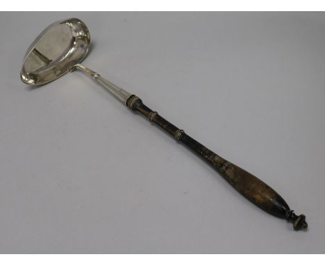 An early 19th Century Swedish silver ladle with turned wooden handle, date letter for 1837, 41.5cm.