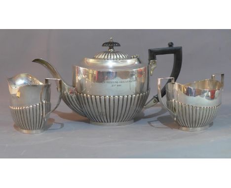 A three piece silver plated tea set, comprising a teapot with Bakelite handle and finial, a twin handled urn shaped sugar bow