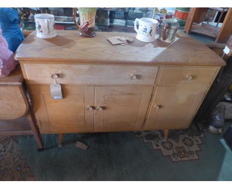 A mid 20th century Ercol sideboard, with two drawers, over three cupboard doors, H.83 W.123 D.45cm 