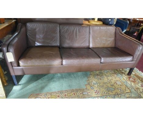 A three seater brown leather sofa 