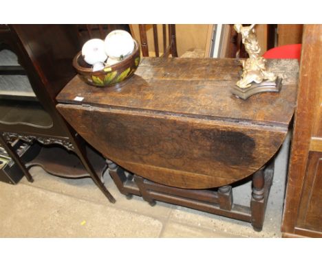 An antique oak gate leg table 