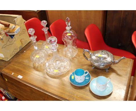 A glass ships decanter and stopper; a pair of Victorian decanters and stoppers and a silver collared decanter; and two Susie 