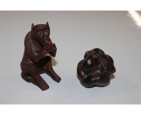A Netsuke in the form of a seated man and a monkey 