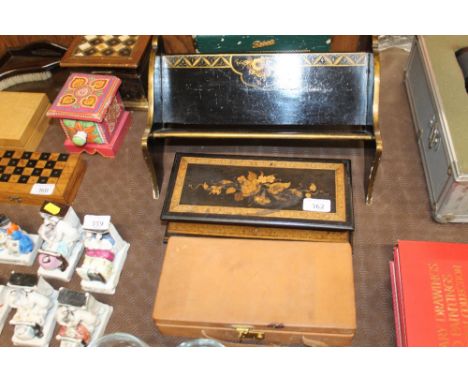 An Asprey of London cantilever jewellery box; a floral marquetry inlaid trinket box; and a chinoiserie decorated book rack