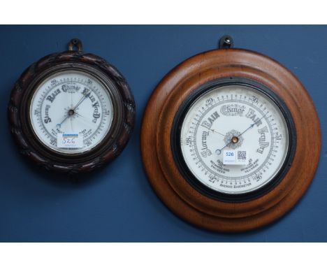 Early 20th century circular aneroid barometer set on oak surround, and an aneroid barometer in oak rope twist surround (2) CL