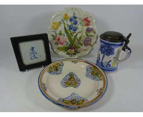 Two 19th/ early 20th Century Delft type plates, 19th Century Delft type tankard and Delft tile (4)   Condition Report   Click