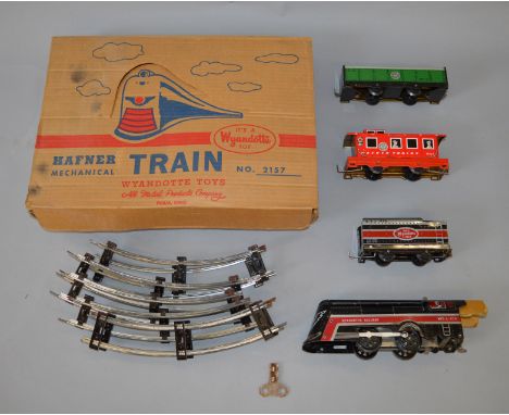 A boxed Hafner clockwork train set (a Wyandotte Toy) including tinplate engine, tender, open truck, guards van, track and key